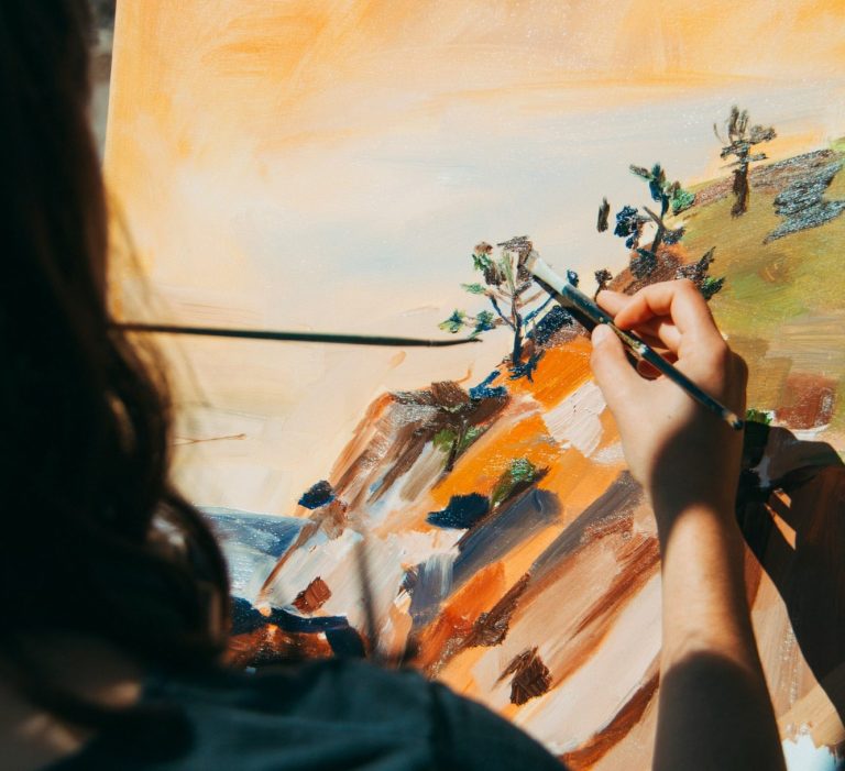 Artist painting canvas representing creative professionals receiving royalties who use Hayes & Co specialist IP accounting in East London